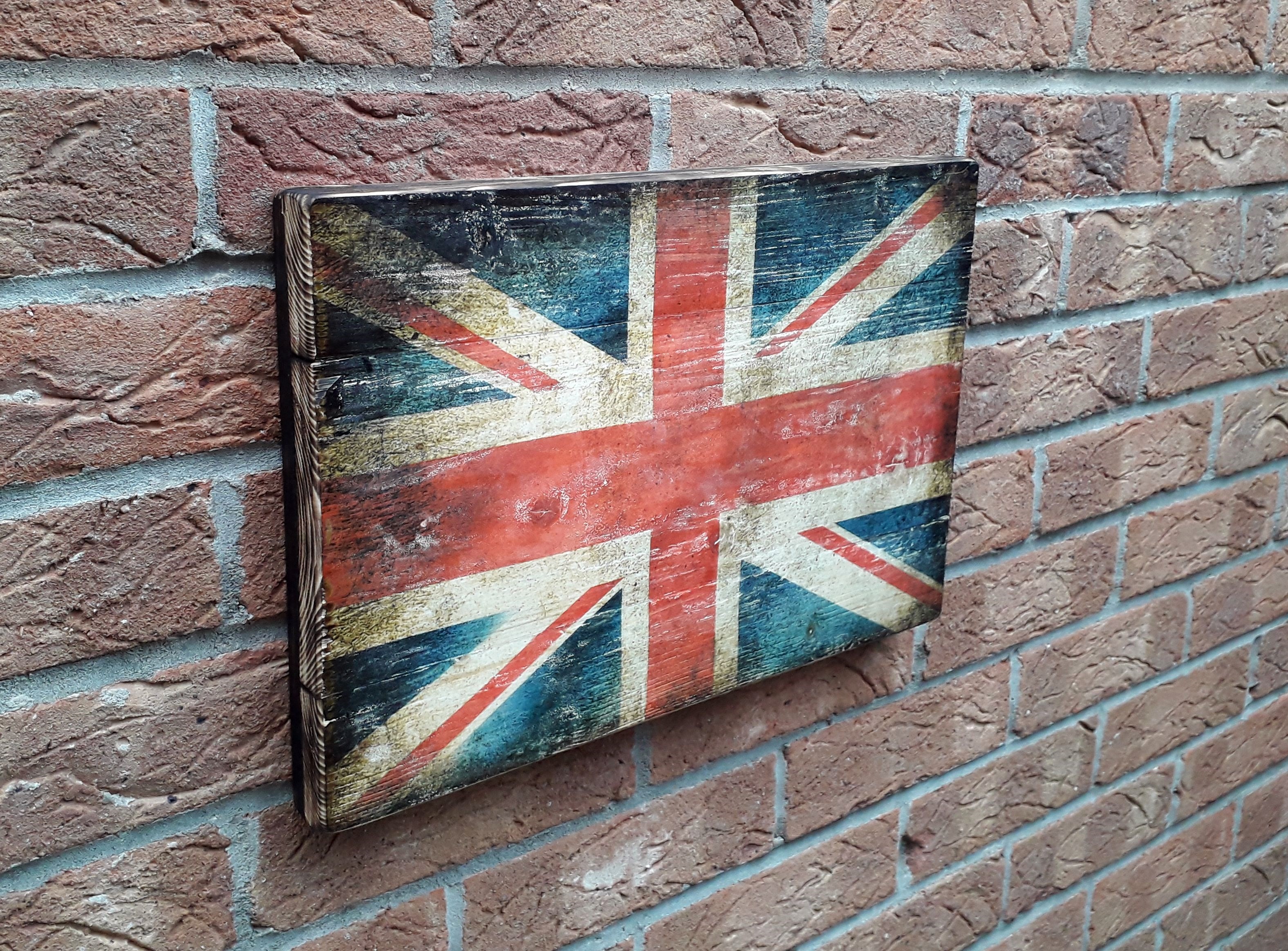 Union Jack flag on the rustic wood with burnt edges